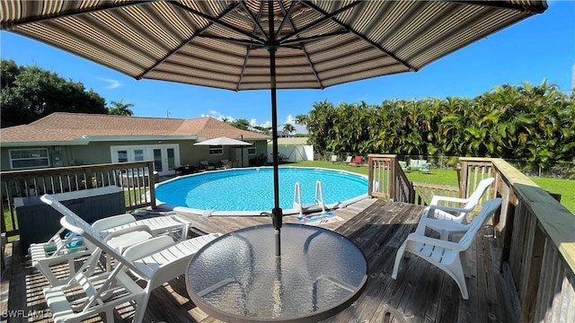 view of swimming pool featuring a yard and a deck