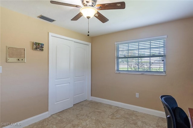 unfurnished office featuring ceiling fan