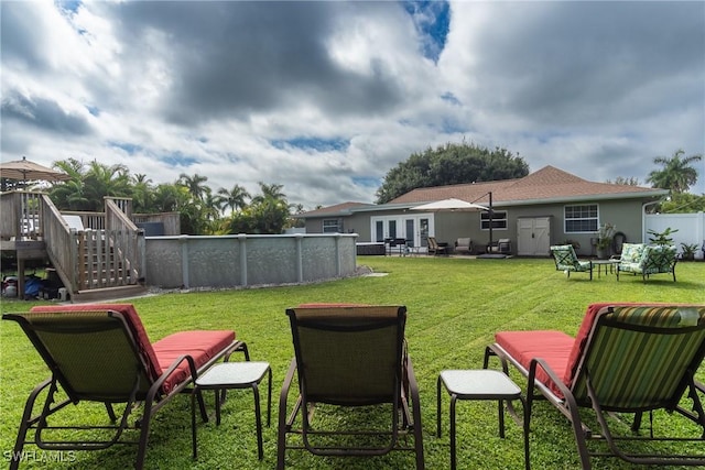 view of yard with a pool side deck