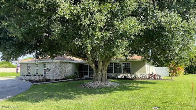 ranch-style house with a front lawn