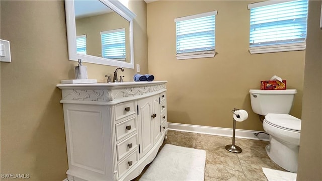 bathroom with tile patterned floors, vanity, and toilet