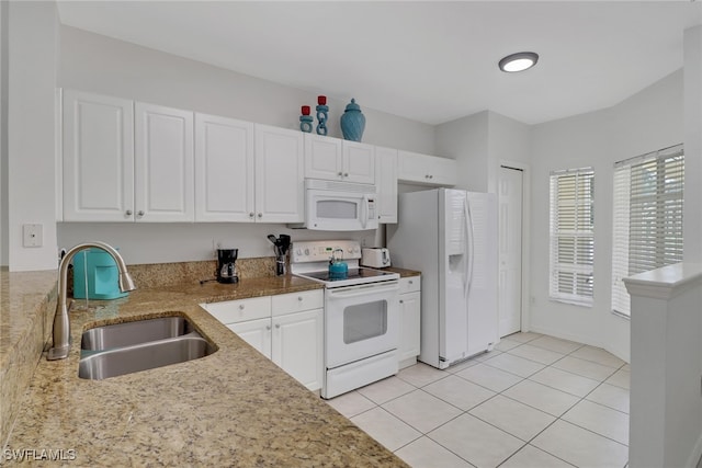 kitchen with sink, white cabinetry, light stone counters, and white appliances