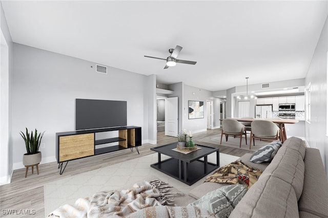 living room featuring light wood-type flooring and ceiling fan