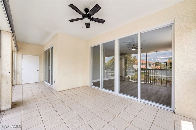 unfurnished sunroom featuring a healthy amount of sunlight and ceiling fan