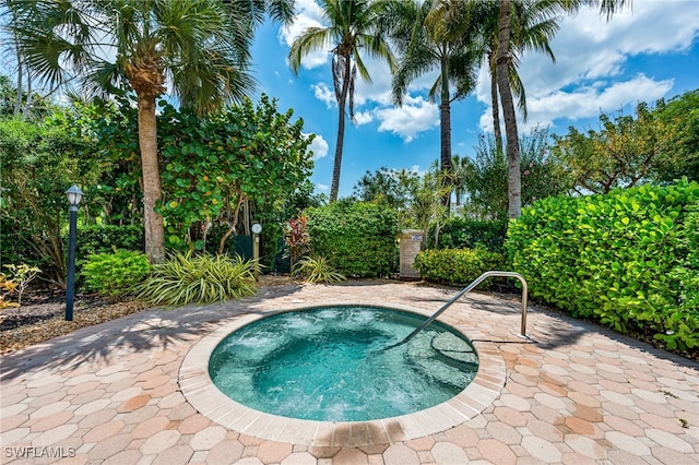 view of pool featuring an in ground hot tub and a patio area