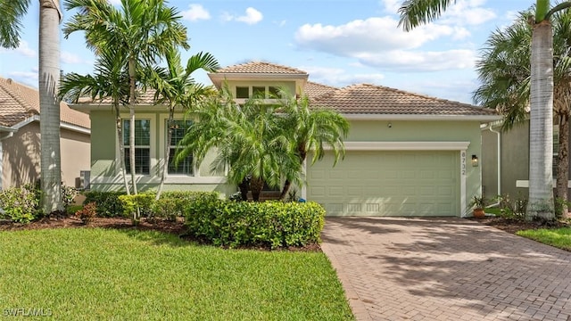 mediterranean / spanish-style house with a front yard and a garage