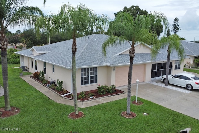 single story home with central AC unit, a garage, and a front yard