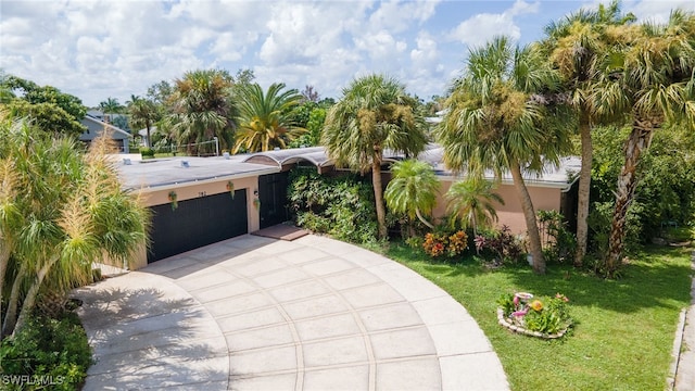 view of front of property featuring a garage and a front yard