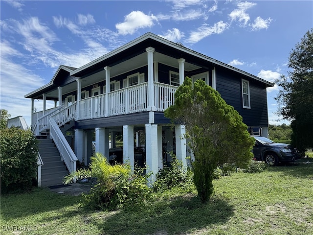 exterior space featuring covered porch and a front yard