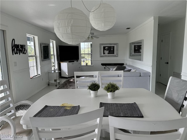 dining area featuring ornamental molding and ceiling fan