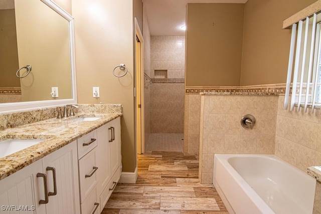 bathroom featuring hardwood / wood-style floors, vanity, tile walls, and shower with separate bathtub