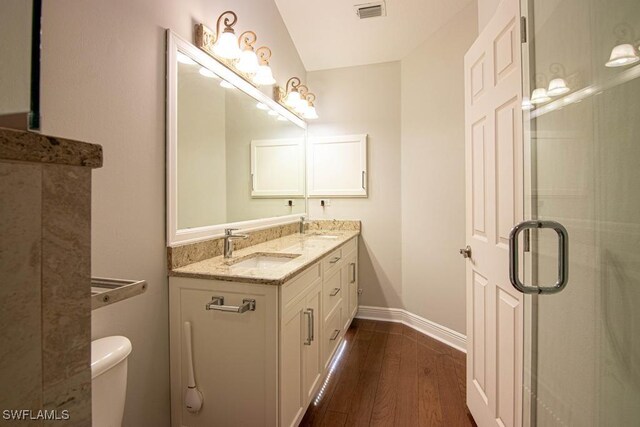 bathroom with vanity, wood-type flooring, an enclosed shower, and toilet