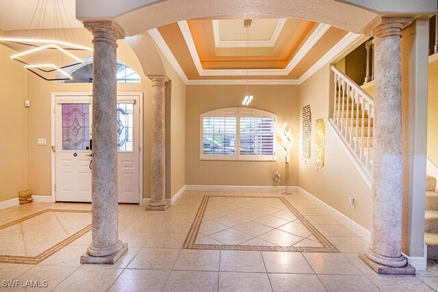 tiled foyer entrance with ornate columns and crown molding