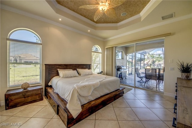 bedroom with visible vents, a sunroom, access to exterior, a tray ceiling, and light tile patterned flooring