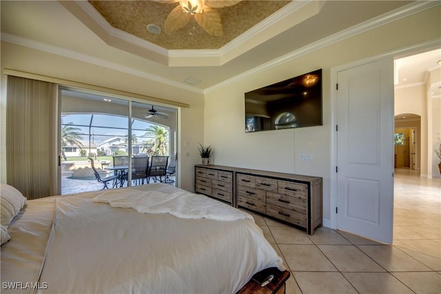 bedroom featuring access to exterior, light tile patterned floors, a tray ceiling, and arched walkways