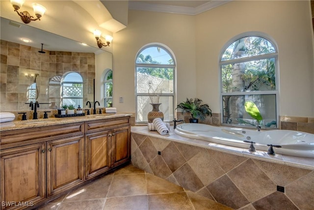 full bathroom featuring crown molding, a sink, a relaxing tiled tub, and double vanity