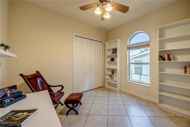 home office with light tile patterned floors, ceiling fan, baseboards, and built in features