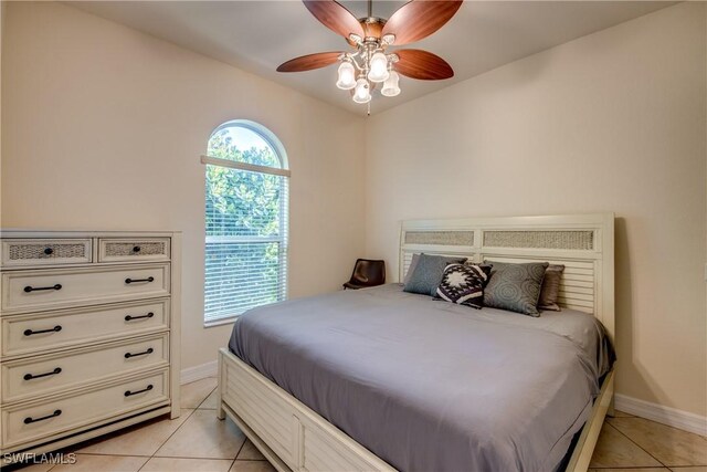 bedroom with ceiling fan and light tile patterned flooring