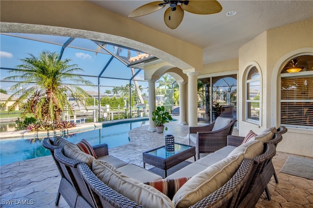 view of patio featuring a lanai, ceiling fan, and outdoor lounge area