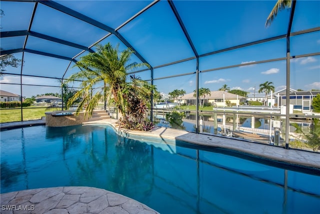 view of pool with a water view, glass enclosure, and a boat dock