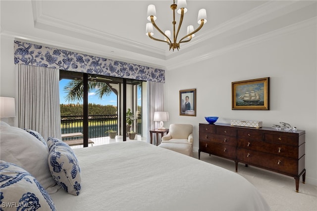 carpeted bedroom with a water view, ornamental molding, a chandelier, a raised ceiling, and access to outside