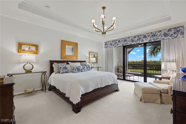 carpeted bedroom featuring access to exterior, a raised ceiling, crown molding, and a notable chandelier