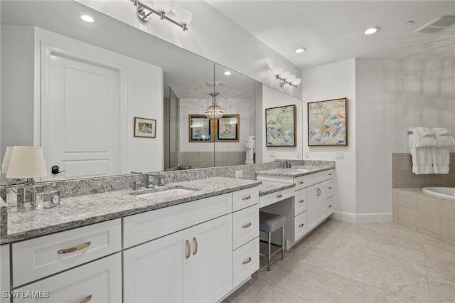 full bath with recessed lighting, visible vents, vanity, tiled tub, and baseboards