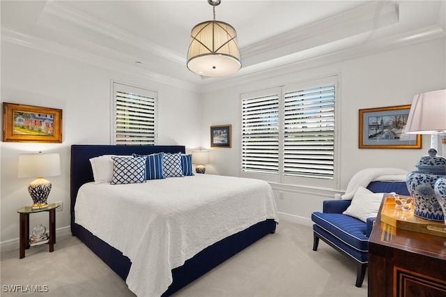 carpeted bedroom featuring ornamental molding and a raised ceiling