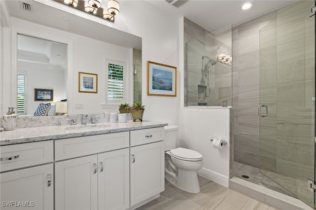 bathroom featuring toilet, a shower stall, visible vents, and vanity