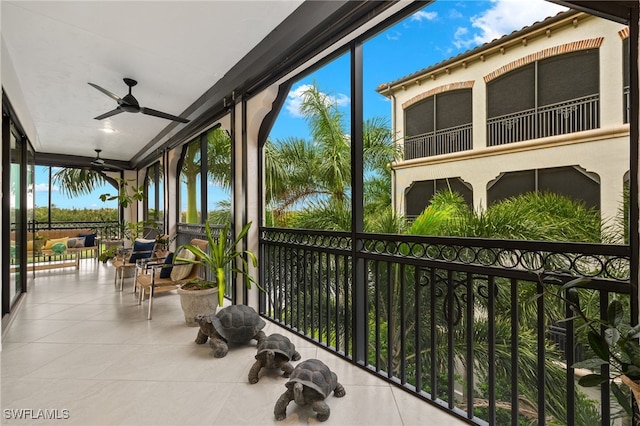 sunroom / solarium featuring ceiling fan