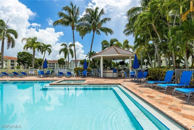 pool featuring fence, a community hot tub, a patio, and a gazebo