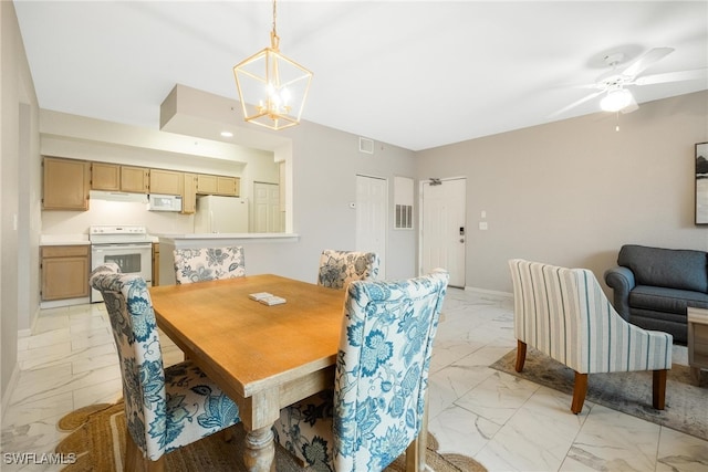 dining space with a notable chandelier, marble finish floor, visible vents, and baseboards