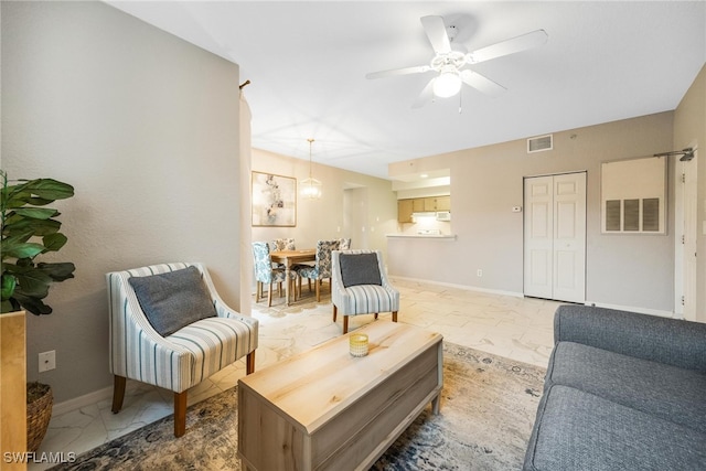 living area featuring marble finish floor, baseboards, and visible vents