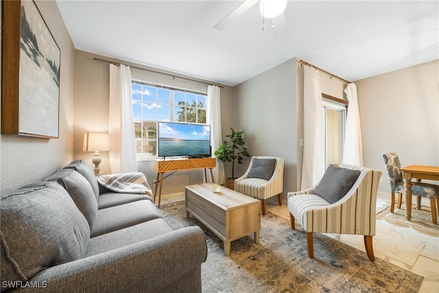 living area with marble finish floor and ceiling fan