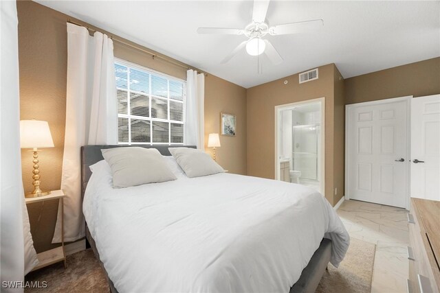 bedroom featuring visible vents, baseboards, a ceiling fan, ensuite bath, and marble finish floor