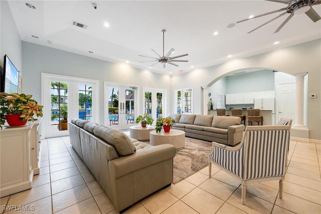 living room featuring french doors, visible vents, ceiling fan, and ornate columns