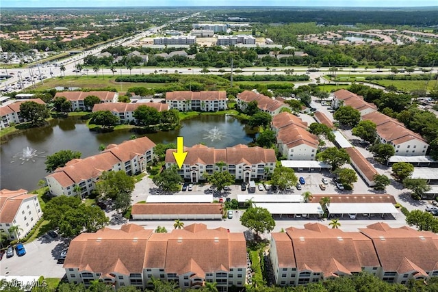 bird's eye view featuring a water view and a residential view