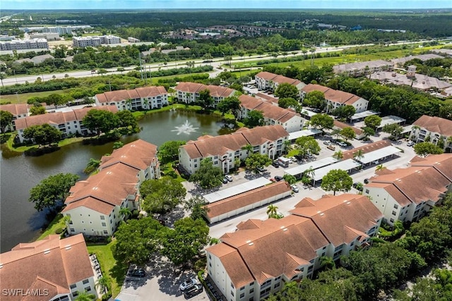 bird's eye view featuring a water view and a residential view