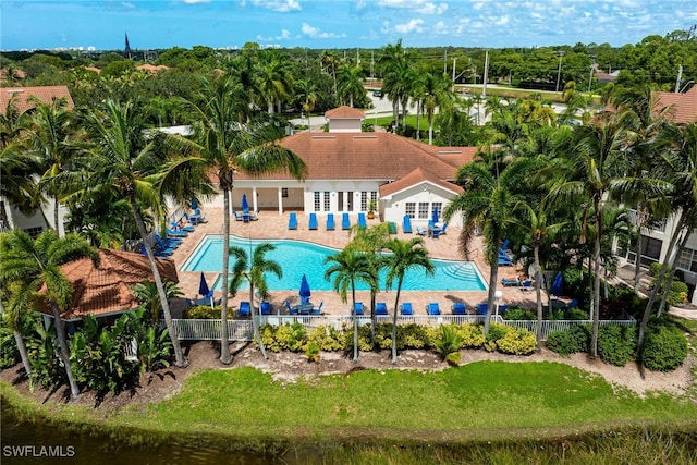 pool with a patio area, fence, and a lawn