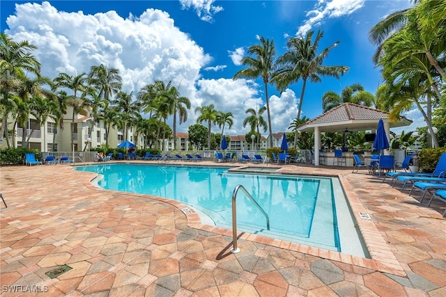 pool featuring a patio area and fence