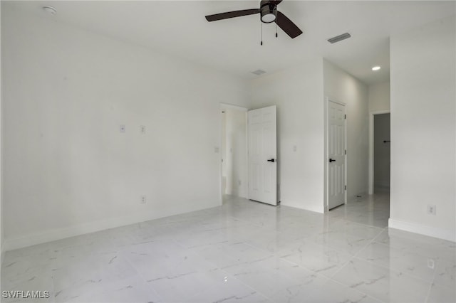 tiled empty room featuring ceiling fan