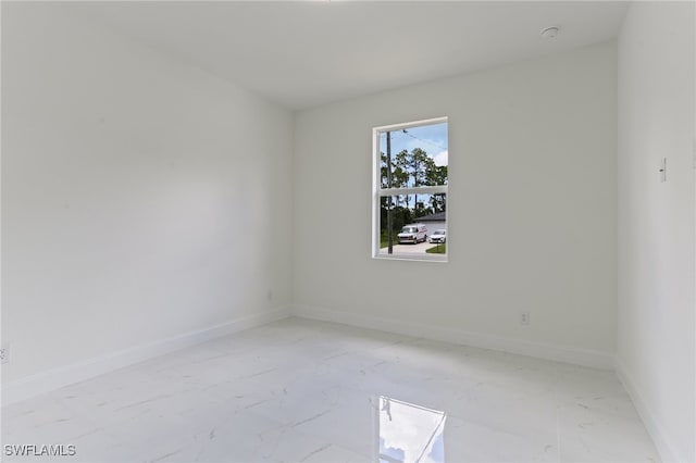 spare room featuring light tile patterned flooring