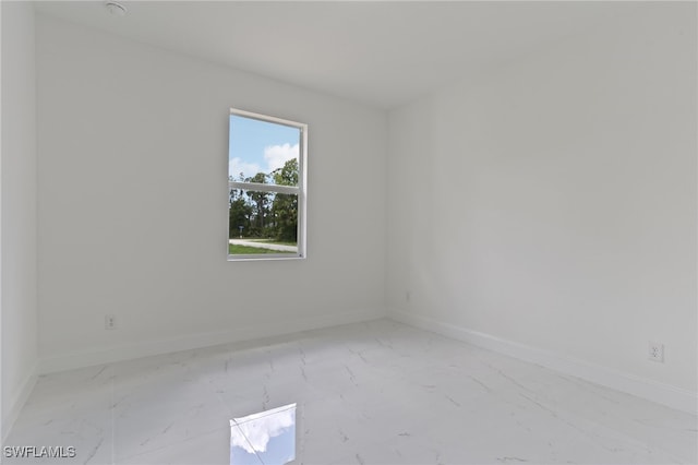 unfurnished room featuring light tile patterned floors