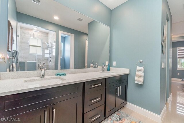 bathroom with vanity, tile patterned flooring, and a shower with door