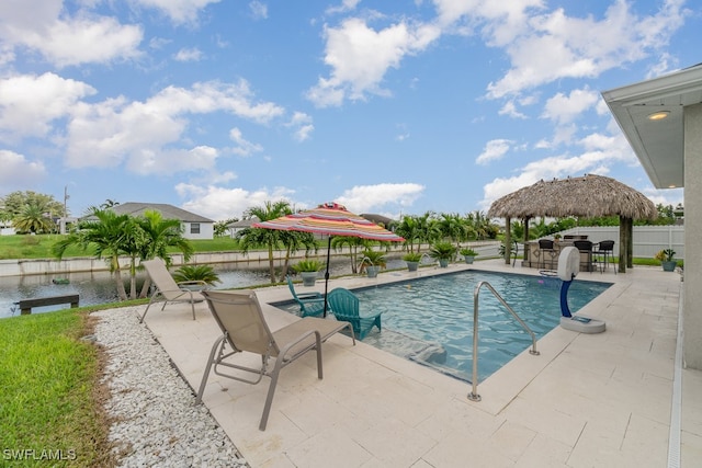 view of swimming pool featuring a patio, a water view, and a gazebo