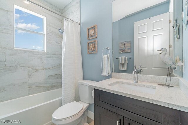 full bathroom featuring shower / tub combo with curtain, vanity, and toilet