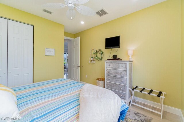 bedroom with wood-type flooring, a closet, and ceiling fan