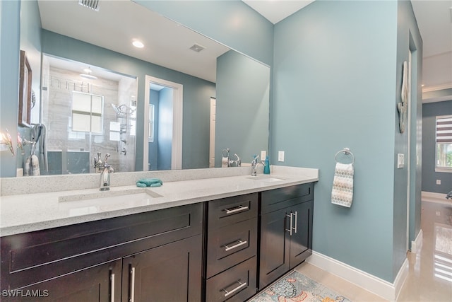 bathroom featuring vanity, tile patterned flooring, and a shower with shower door