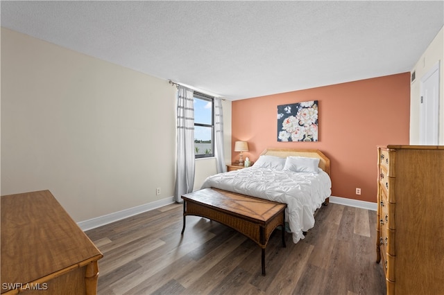 bedroom with a textured ceiling, floor to ceiling windows, and dark hardwood / wood-style floors