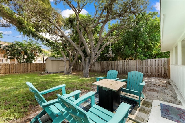 view of patio with a fenced backyard, an outdoor structure, and a storage shed